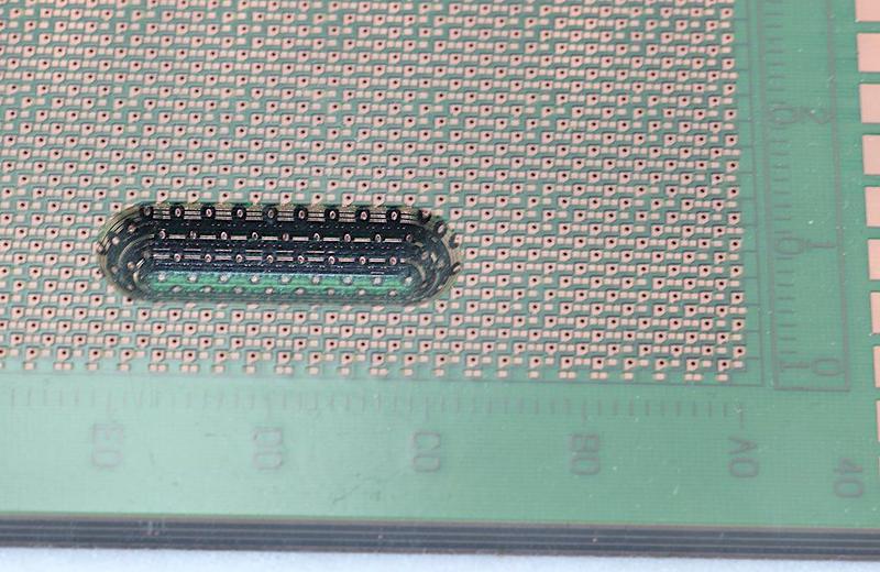 Closeup of the printed circuit board used in the IBM 3090. The routed groove shows the multi-layer construction.